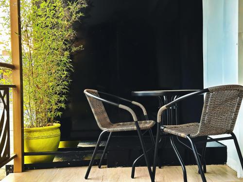 two chairs and a table on a patio at Karen Plains Hotel Nairobi in Nairobi