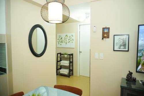 a dining room with a mirror and a table at Cozy 2 Bedroom Condo with Balcony for Rent in Iloilo City