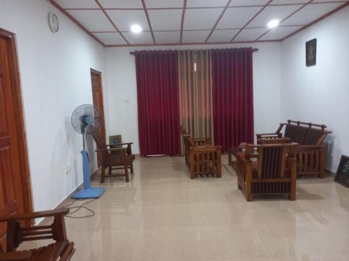 a waiting room with wooden chairs and a fan at New Forest Glen Nest in Ella