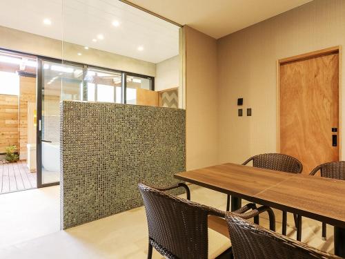 a dining room with a wooden table and chairs at Hotel 4CROWNS- PREMIEREプラチナプラン in Katsuyama