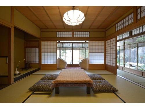a room with a large table in a room with windows at Jeugiya - Vacation STAY 87441v in Kyoto