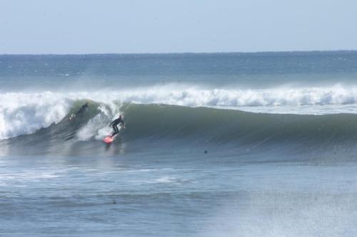 a person riding a wave on a surfboard in the ocean at Hide A Way - Vacation STAY 90104v in Nishinoomote