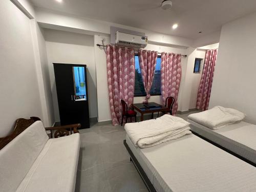 Postel nebo postele na pokoji v ubytování Hotel Nalanda Guest House