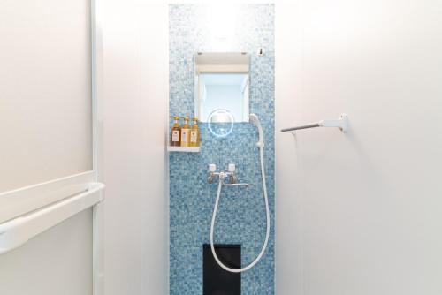 a shower in a bathroom with blue tiles at Grandioso Okinawa Villa Kin 2 - Vacation STAY 24799v in Yaka