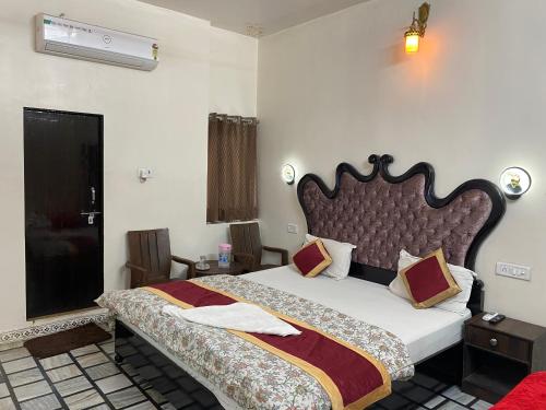 a bedroom with a large bed in a room at Hotel Vacation in Jaipur