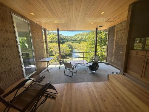 a room with a table and chairs and a large window at Ayu House - Vacation STAY 03971v in Nagahama