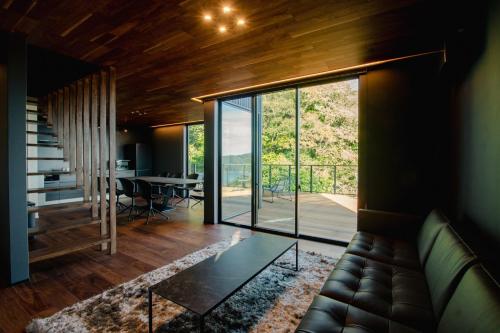 a living room with a couch and a table at Awaji-shima C-Side Dual View - Vacation STAY 88182v in Minamiawaji