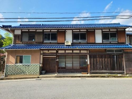 a house with a fence and a gate on a street at Ayu House - Vacation STAY 03971v in Nagahama