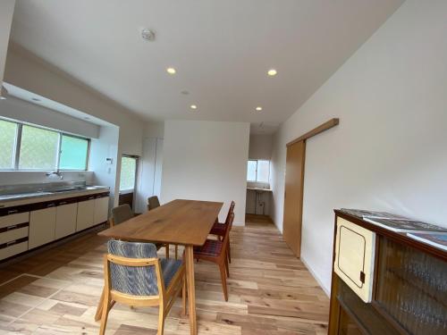a kitchen and dining room with a wooden table and chairs at Ayu House - Vacation STAY 03971v in Nagahama