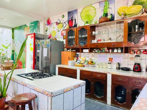 a kitchen with a stove and a refrigerator at Sarisa House in Iquitos