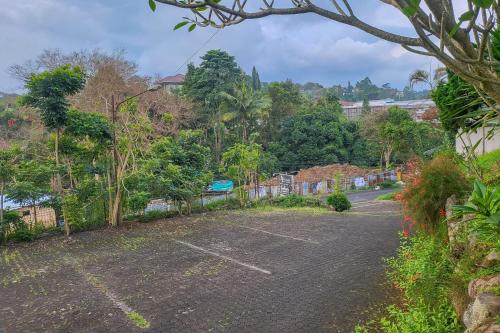 an empty parking lot with trees in the background at RedDoorz near UPI Setiabudhi Bandung in Bandung