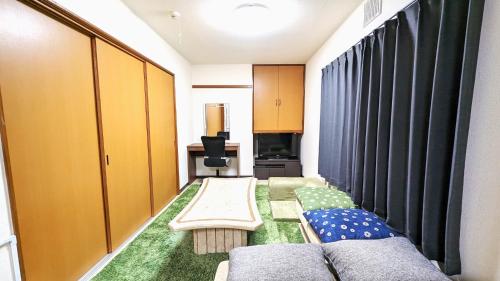 a living room with a couch and a table at Gran Cattleya Kikusui - Vacation STAY 13265 in Sapporo