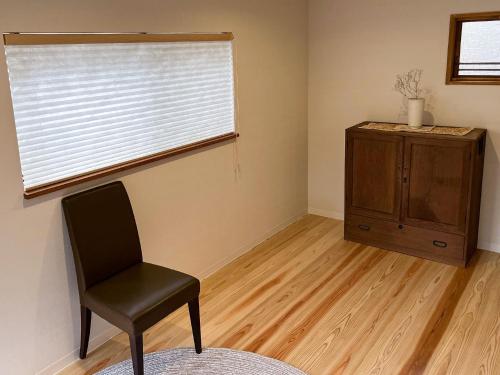 a room with a chair and a window and a dresser at Asuka no yado - Vacation STAY 14132 in Asuka