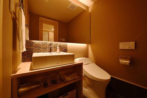 a bathroom with a sink and a toilet and a mirror at Kyoyado Heianshiki - Vacation STAY 00358v in Kyoto