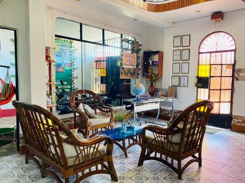 a living room with a table and chairs and a desk at Sarisa House in Iquitos