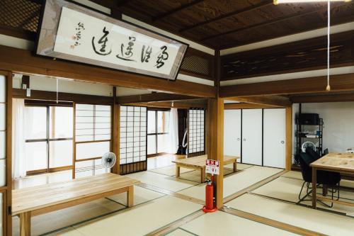 a room with benches and windows in a building at Worcation base Kaminyu Yamane House - Vacation STAY 03960v in Nagahama