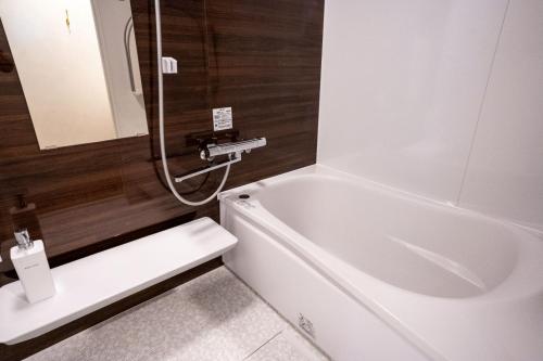 a bathroom with a white bath tub and a sink at Trailer room - Vacation STAY 06457v in Makinohara