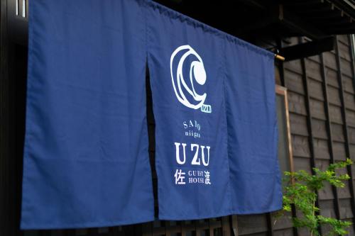 a blue banner is hanging in front of a building at guesthouse UZU Sado - Vacation STAY 01100v in Sado