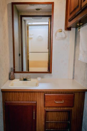 a bathroom with a sink and a mirror at MUUN Beach Club in Ciudad del Carmen
