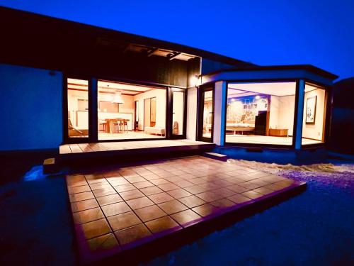 a large house with a patio at night at Yufuin Tsukawara Kogen Sanctuary - Vacation STAY 91378v in Yufu
