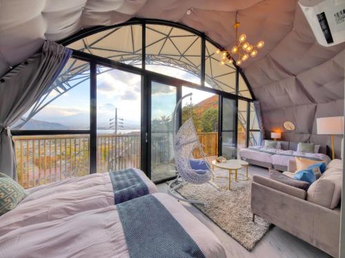 a bedroom with a bed and a large window at Mt,Fuji Glamping Terrace Minenohana - Vacation STAY 35071v in Oishi