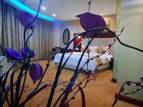 Postel nebo postele na pokoji v ubytování Wanxiang Hotel
