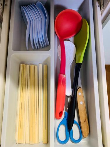 a drawer filled with utensils and other kitchen items at Maisonette Hanazono - Vacation STAY 97278v in Chiba