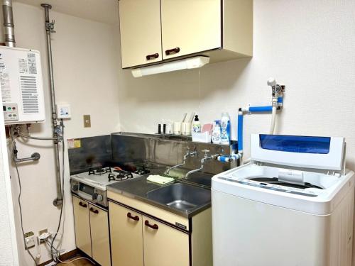 a kitchen with a sink and a stove at Gran Cattleya Kikusui - Vacation STAY 13264 in Sapporo