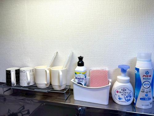a shelf with toothbrushes and other bathroom items on it at Gran Cattleya Kikusui - Vacation STAY 13264 in Sapporo