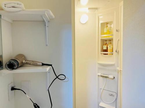 a room with a small refrigerator with bottles in it at Fukuinn - Vacation STAY 35094v in Takamatsu