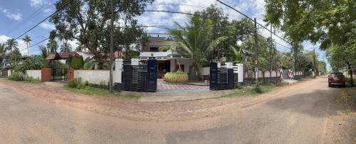 a house on the side of a dirt road at Soul Shore, Varkala in Varkala