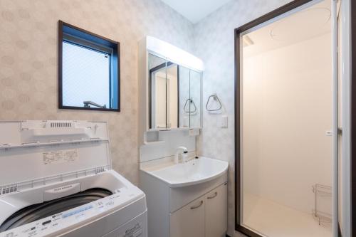 a bathroom with a washing machine and a sink at FAMILIA Kojiya - Vacation STAY 15710 in Tokyo