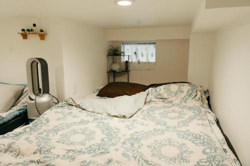 a bedroom with a bed with a blanket on it at Designer's apartment polaris 102 - Vacation STAY 13315 in Nagoya