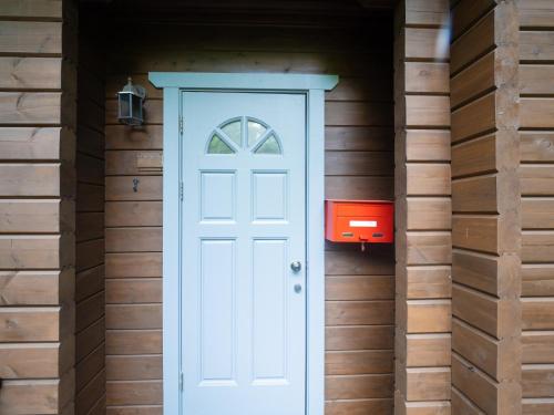 a white door in a wooden house with a red mailbox at Nasu-gun - House - Vacation STAY 13478 in Anazawa