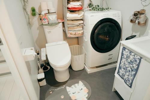 a bathroom with a toilet and a washing machine at Designer's apartment polaris 102 - Vacation STAY 13315 in Nagoya