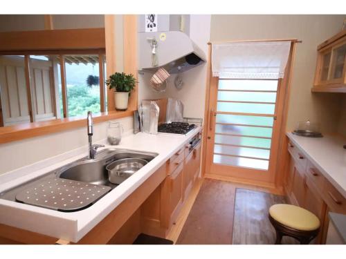 a kitchen with a sink and a stove at Villa MITORE-YA - Vacation STAY 13536 in Takayama