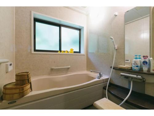 a bathroom with a bath tub and a window at Shikouan - Vacation STAY 55494v in Higashi-shibuta