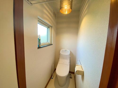 a small bathroom with a toilet and a window at PortFront - Vacation STAY 60869v in Shiraoi