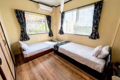 En eller flere senge i et værelse på BoBo's HOUSE - Vacation STAY 95198v