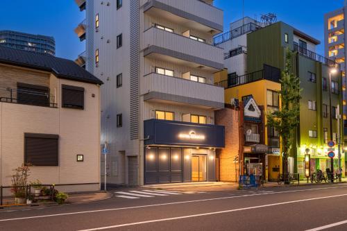 an empty street in a city with tall buildings at HOTEL KOMACHI TOKYO Higashi Nippori in Tokyo