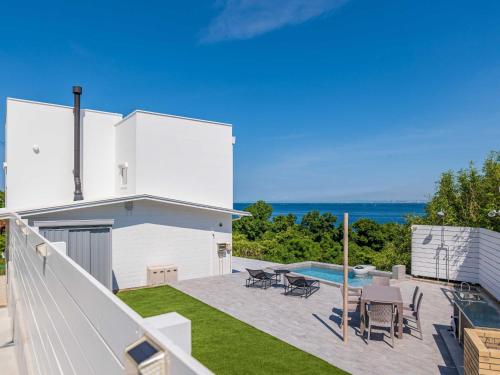 a white house with a patio and a swimming pool at NE-2930 - Vacation STAY 68092v in Awaji