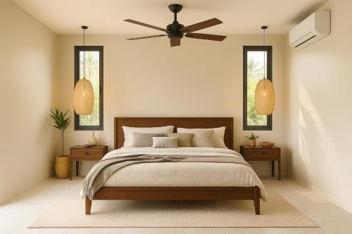a bedroom with a bed and a ceiling fan at KUUL Villas in Baan Tai