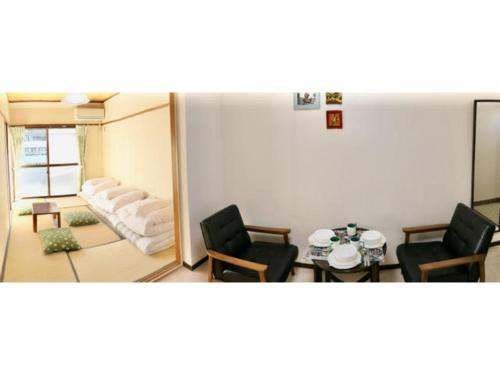 a living room with two chairs and a mirror at Aoisora Aoiumi no guest house - Vacation STAY 75101v in Takamatsu