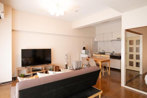 a living room with a couch and a table at RIVER WEST Hiroshima 302, 305, 306 - Vacation STAY 54100v in Ōsukachō