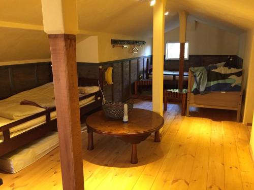 a room with a bed and a table in a room at Chibikko House KK - Vacation STAY 54176v in Oshima