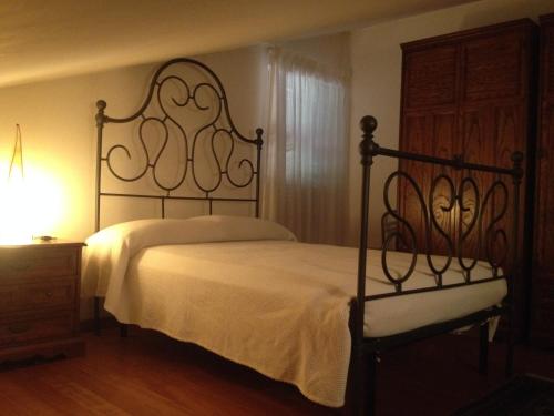 a bedroom with a large bed with a white bedspread at La Spiga in Rieti