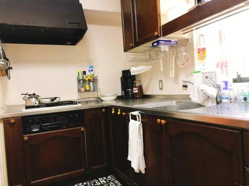a kitchen with a sink and a counter top at Guest House SAKURA - Vacation STAY 57751v in Sakura
