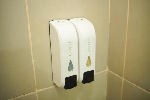 two wii controllers hanging on a wall in a bathroom at Cozy 2 Bedroom Condo with Balcony for Rent in Iloilo City