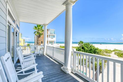 a porch with white chairs and the beach at A Pirate's Paradise in St. Augustine
