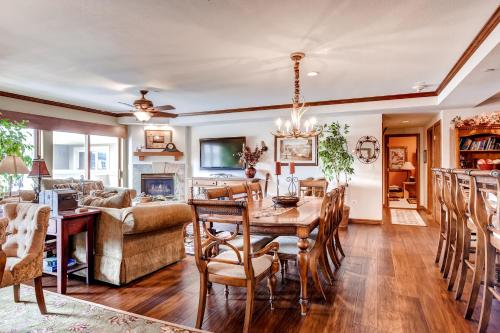 a dining room and living room with a table and chairs at St. James Place in Beaver Creek